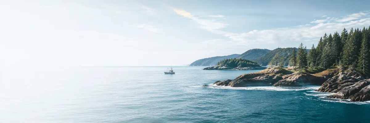 Rocky Canadian coastline and ocean beneath an open sky