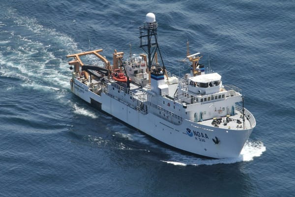 NOAA oceanographic research vessel underway at sea, viewed from above with scientific equipment visible on deck.
