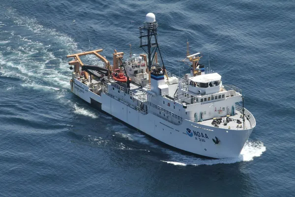 NOAA oceanographic research vessel underway at sea, viewed from above with scientific equipment visible on deck.